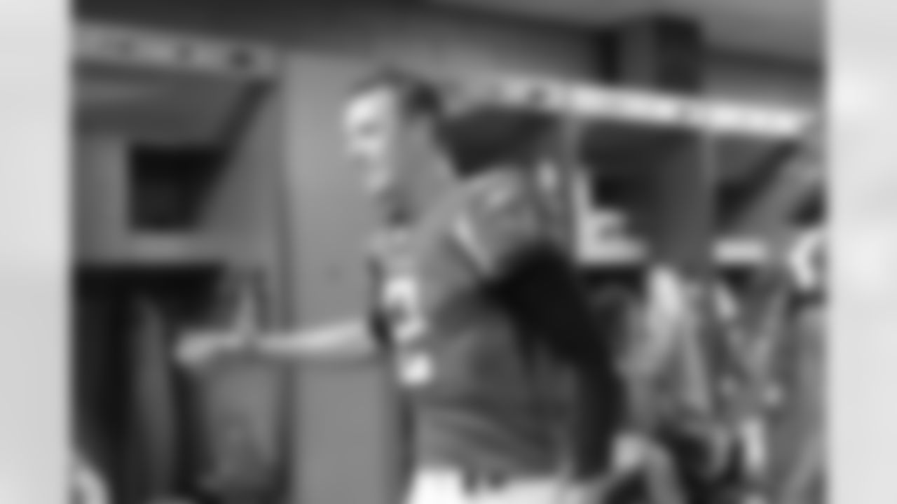 QB Matt Ryan high fives his teammates in the locker room