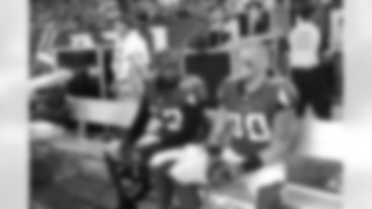 LB Brian Banks and LB Pat Schiller converse on the bench