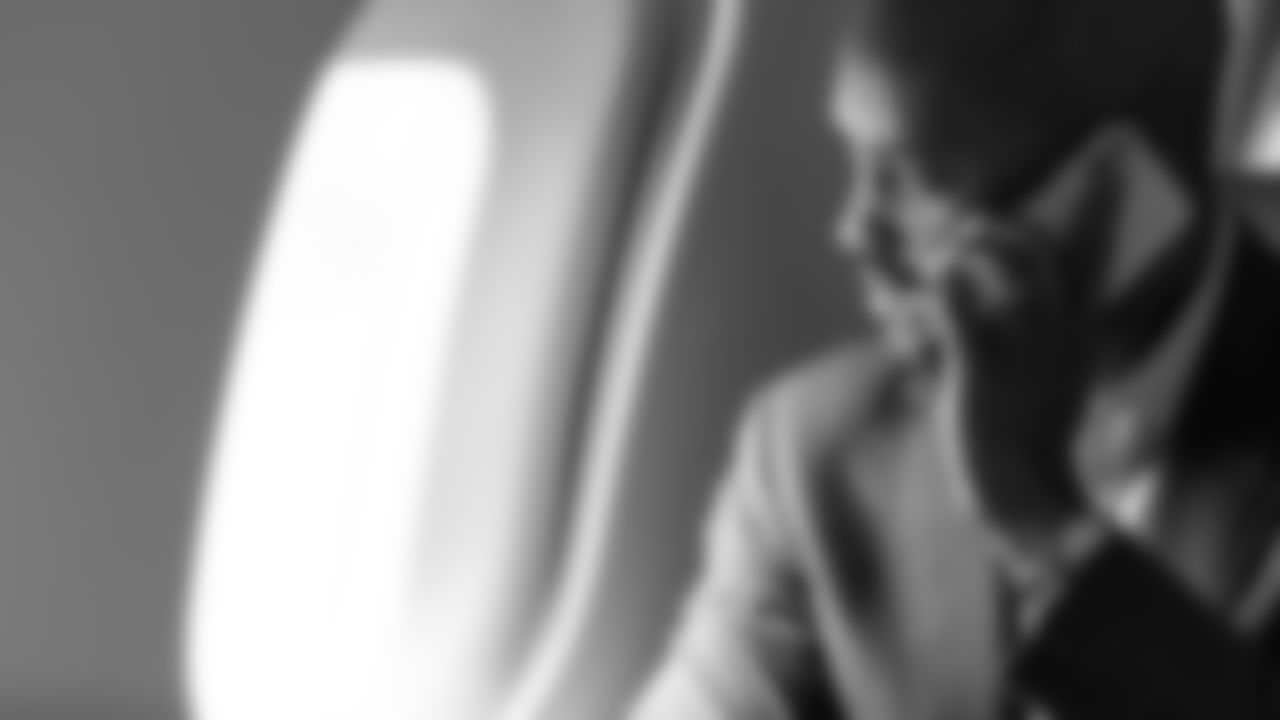 Atlanta Falcons General Manager Terry Fontenot looks out through a window as he takes a phone call during the jet ride to Atlanta, Georgia, on Thursday January 21, 2021.