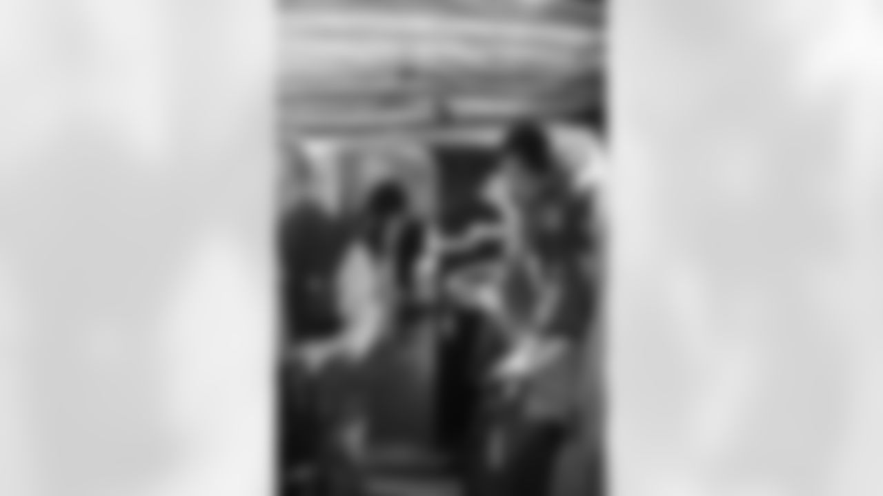 Several Falcons traded places with AirTran workers to marshal planes, take tickets and greet passengers // Trading Places - AirTran // Nov. 1, 2011 // Atlanta -