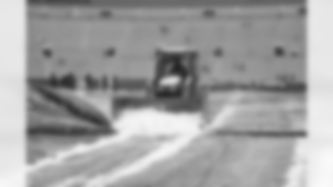 The grounds crew at Lambeau Field working overtime to get all the snow off the field