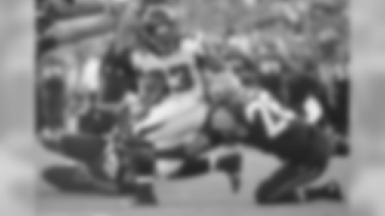 RB Devonta Freeman shakes off a tackle by Jaguars' S Josh Evans.