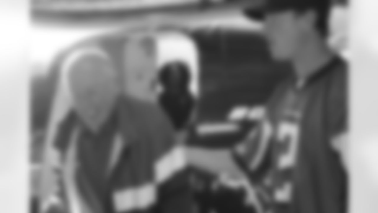 Several Falcons traded places with AirTran workers to marshal planes, take tickets and greet passengers // Trading Places - AirTran // Nov. 1, 2011 // Atlanta -