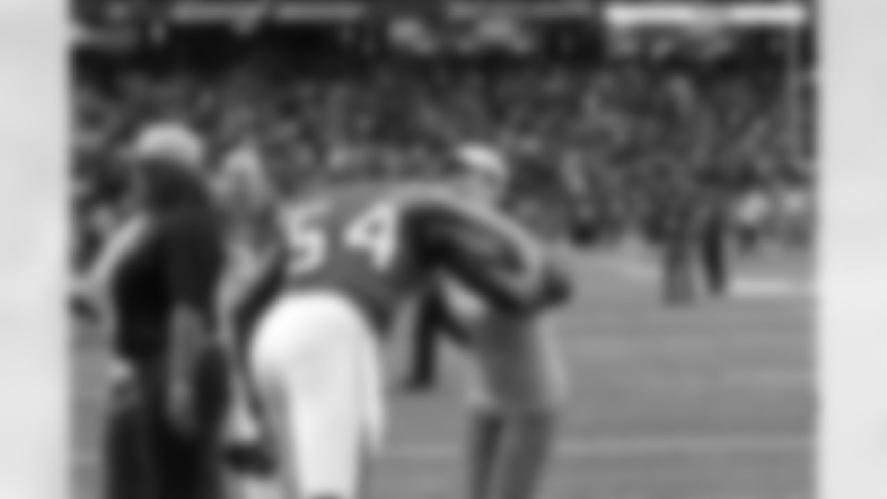 LB Stephen Nicholas hugs a breast cancer survivor pre-game