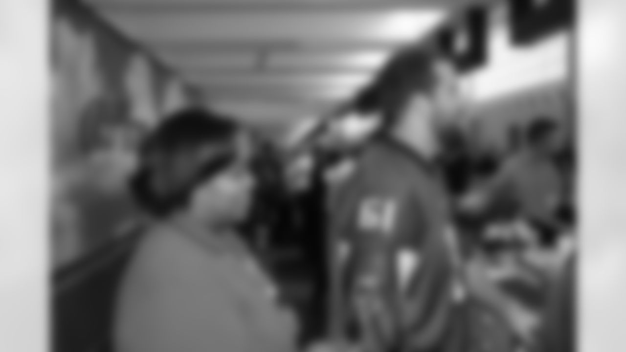 Several Falcons traded places with AirTran workers to marshal planes, take tickets and greet passengers // Trading Places - AirTran // Nov. 1, 2011 // Atlanta -