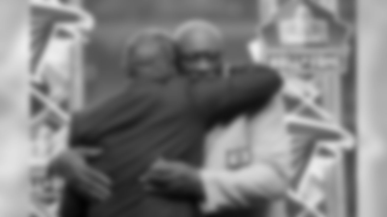 Falcons Alumni Claude Humphrey hugs Owner & Chairman Arthur Blank as he is honored during half time.