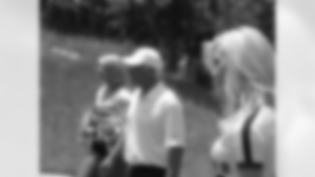 Falcons cheerleaders Reneau K., left, and Jamie K., right, bookend Coach Smith before a group photo // Seventh Annual Verizon Network of Champions Golf Tournament // 6/13/11 // Suwanee, Ga. -