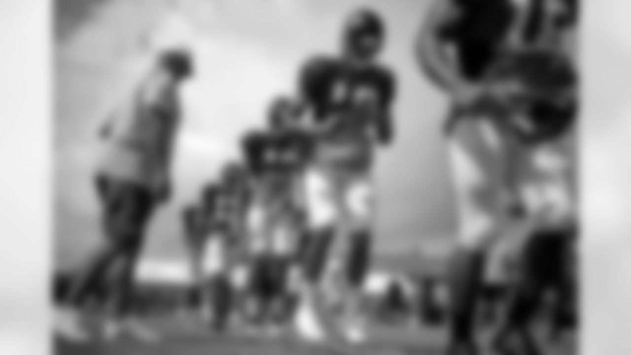 Atlanta Falcons' Marcus Jackson, second from right, runs through a drill with teammates during training camp