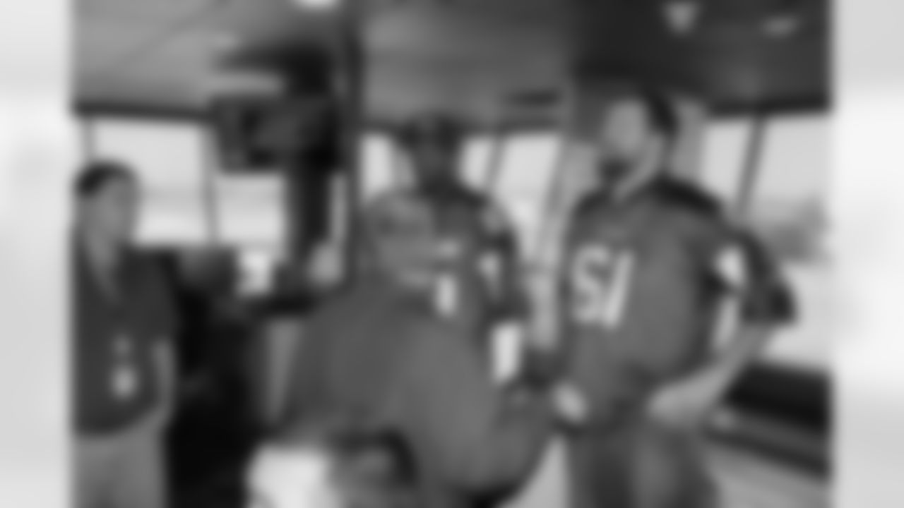 Several Falcons traded places with AirTran workers to marshal planes, take tickets and greet passengers // Trading Places - AirTran // Nov. 1, 2011 // Atlanta -