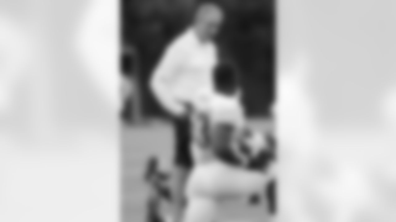 Falcons owner and chairman Arthur Blank speaks with linebacker Prince Shembo