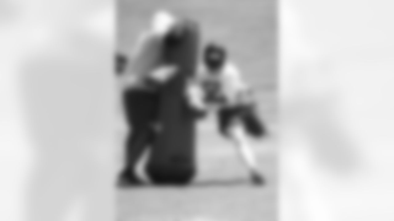 LB Sean Weatherspoon works his way around a tackling dummy held by defensive line coach Bryan Cox