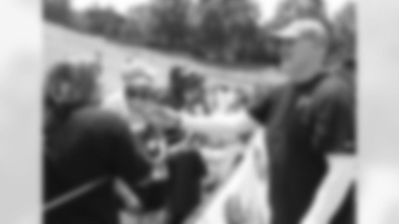 Head coach Dan Quinn takes photos with fans and signs autographs