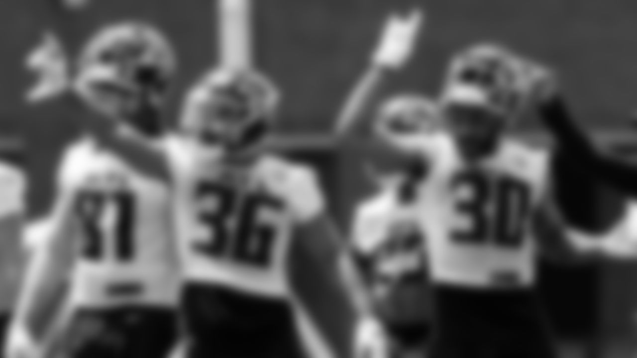 Running backs gesture during organized team activities in Phase III of the Atlanta Falcons offseason program on May 26, 2021.