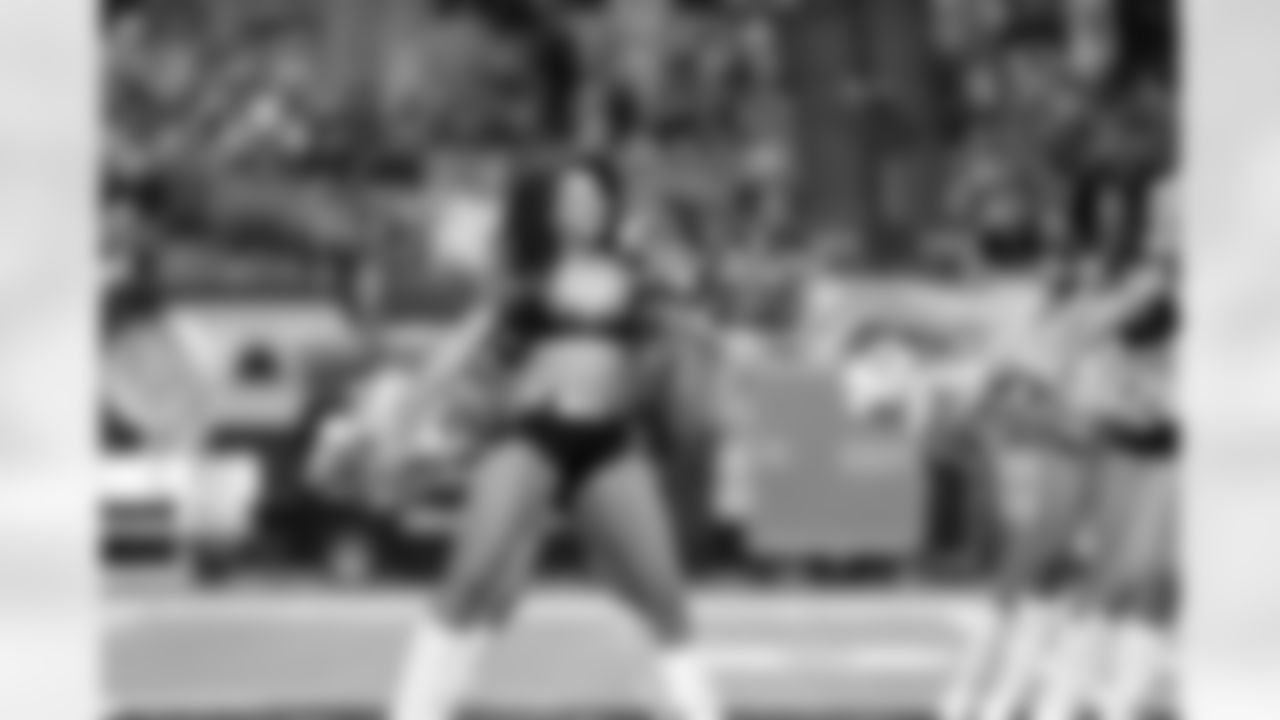 Brittiney W. and the rest of the Atlanta Falcons cheerleaders smile as they perform on the field (PHOTOS: Art Morrison, Special to AtlantaFalcons.com)