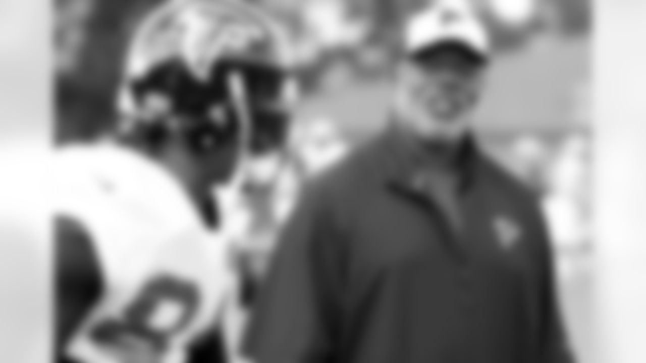 Secondary coach, Tim Lewis, talks to WR Roddy White