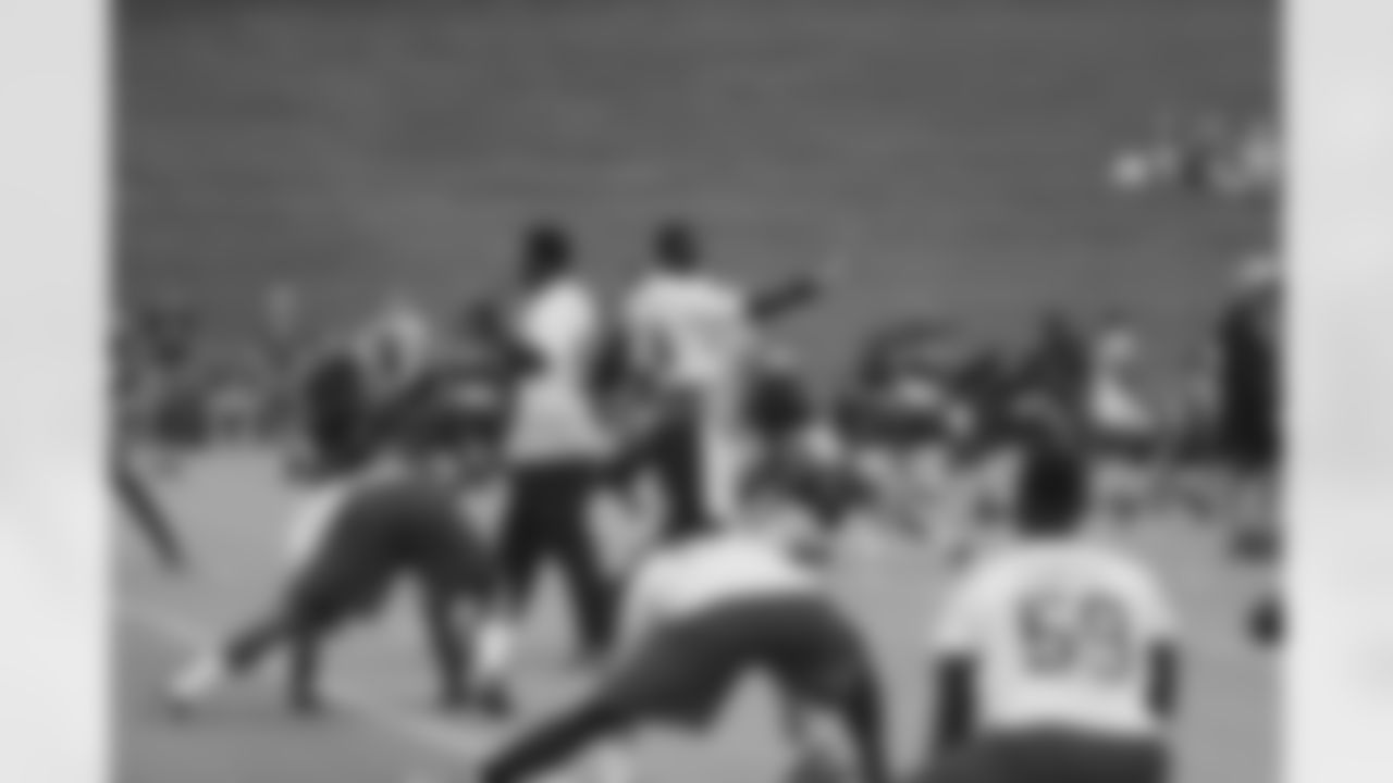 Linebackers Sean Weatherspoon and Stephen Nicholas get ready for stretches with their own handshake