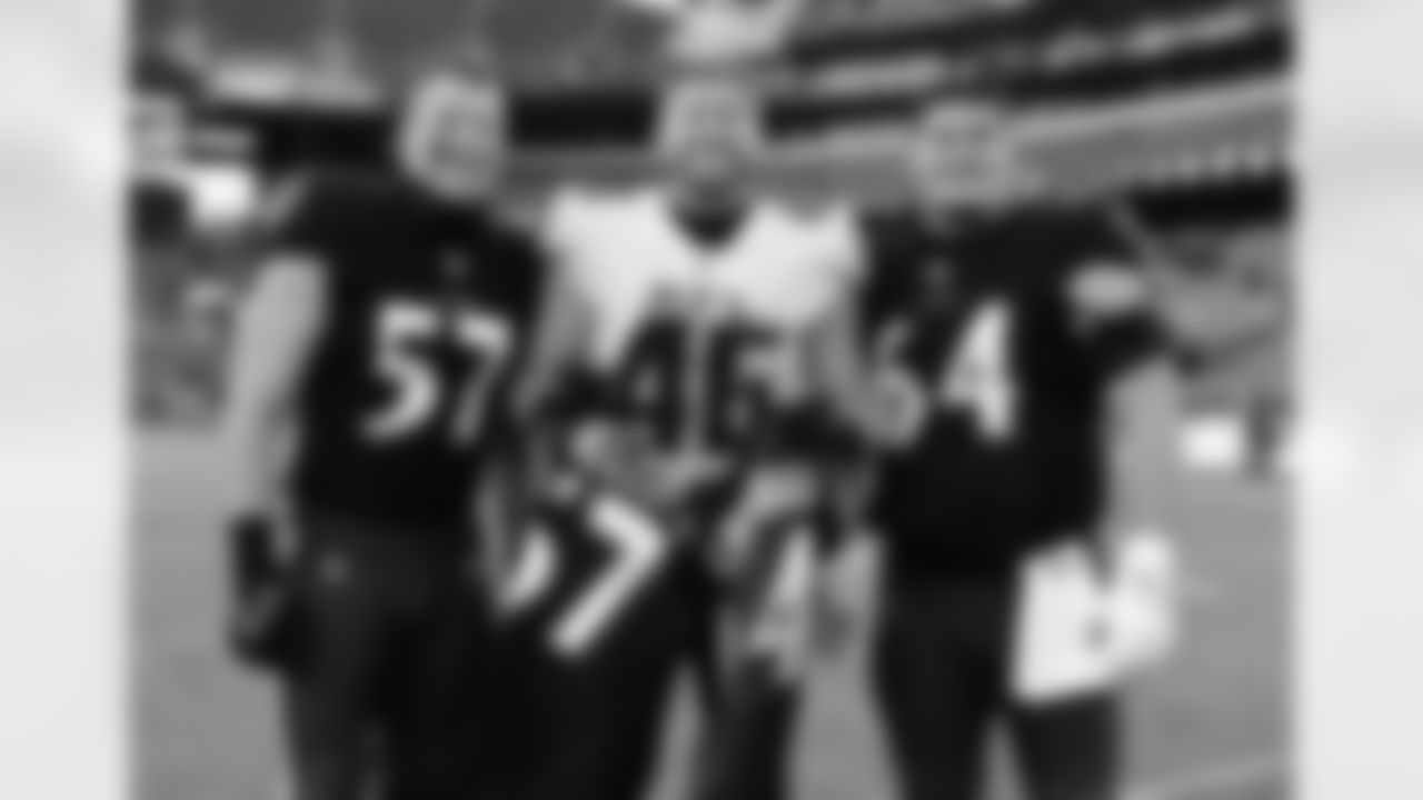 Atlanta Falcons tight end Parker Hesse #46 poses with Baltimore Ravens linebacker Kristian Welch #57 and center Tyler Linderbaum #64 after their game at M&T Bank Stadium in Baltimore, Maryland on Saturday, December 24, 2022. (Photo by David Dermer/Atlanta Falcons)