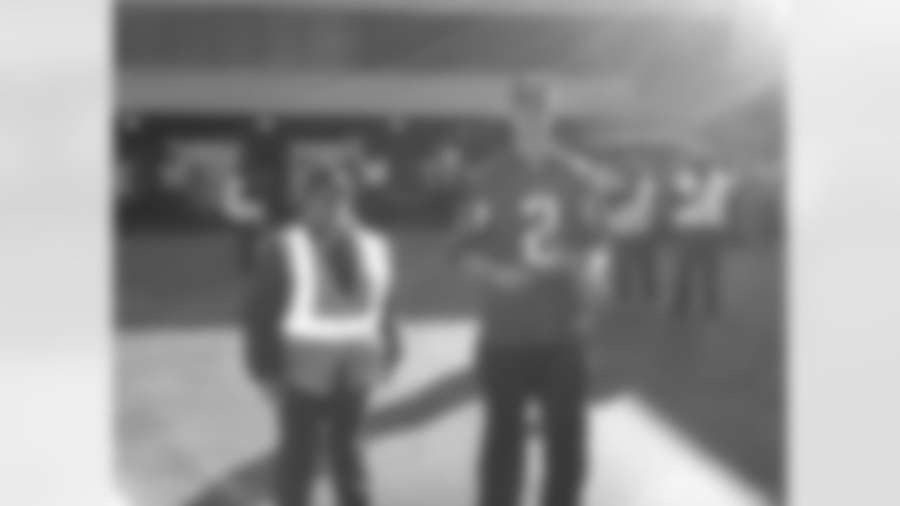 Matt Ryan gets ready to marshal a plane into the terminal // Trading Places - AirTran // Nov. 1, 2011 // Atlanta -