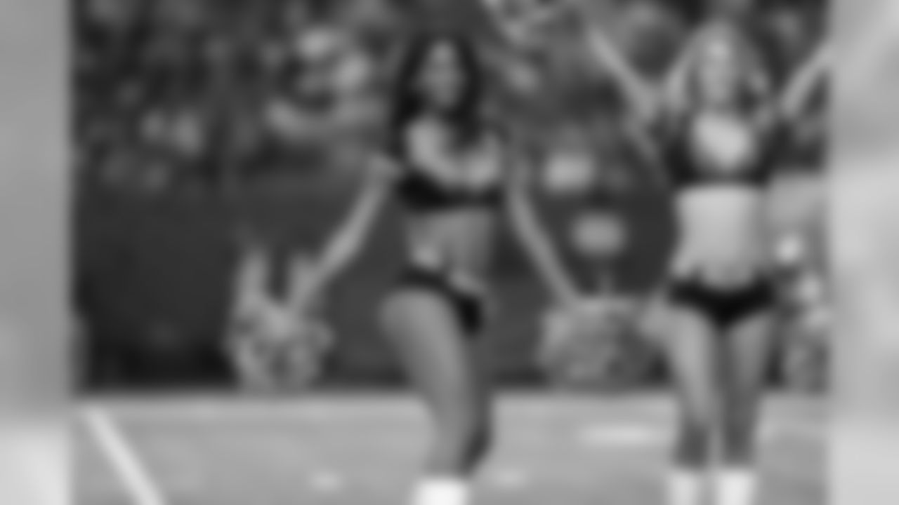 The Atlanta Falcons Cheerleaders perform in a holiday themed halftime during the Falcons vs. Cowboys game