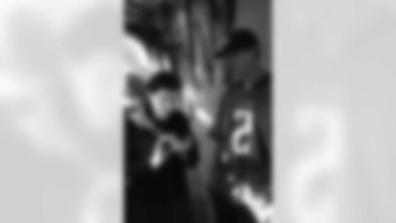 Several Falcons traded places with AirTran workers to marshal planes, take tickets and greet passengers // Trading Places - AirTran // Nov. 1, 2011 // Atlanta -
