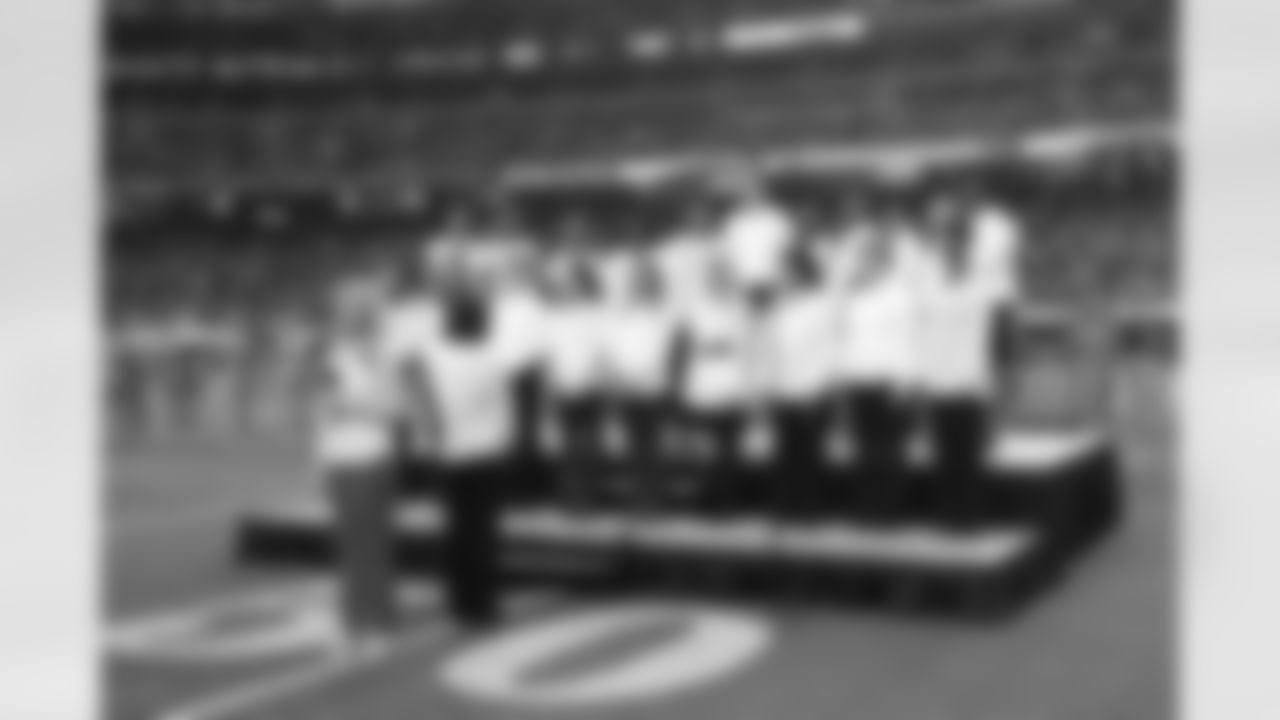 Vocalist Heather Ghram and choir performed God Bless America during halftime