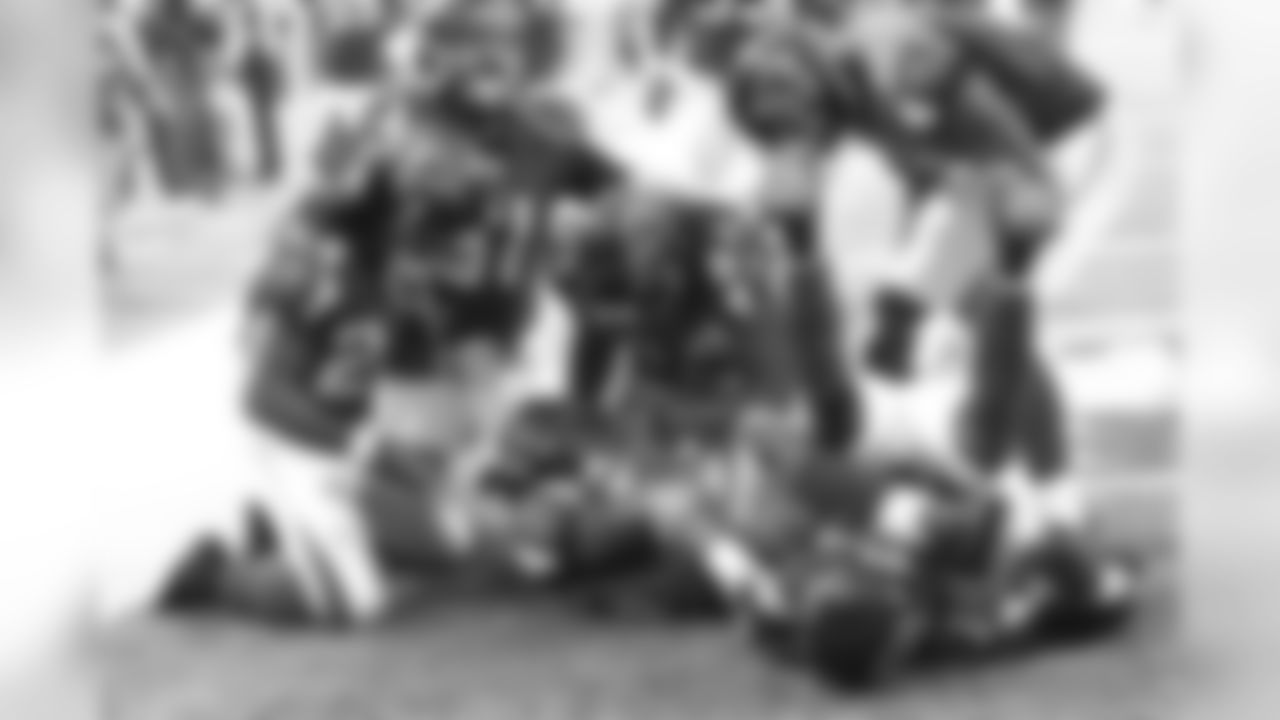 Players tackle RB Antone Smith in the endzone after he scores a touchdown.