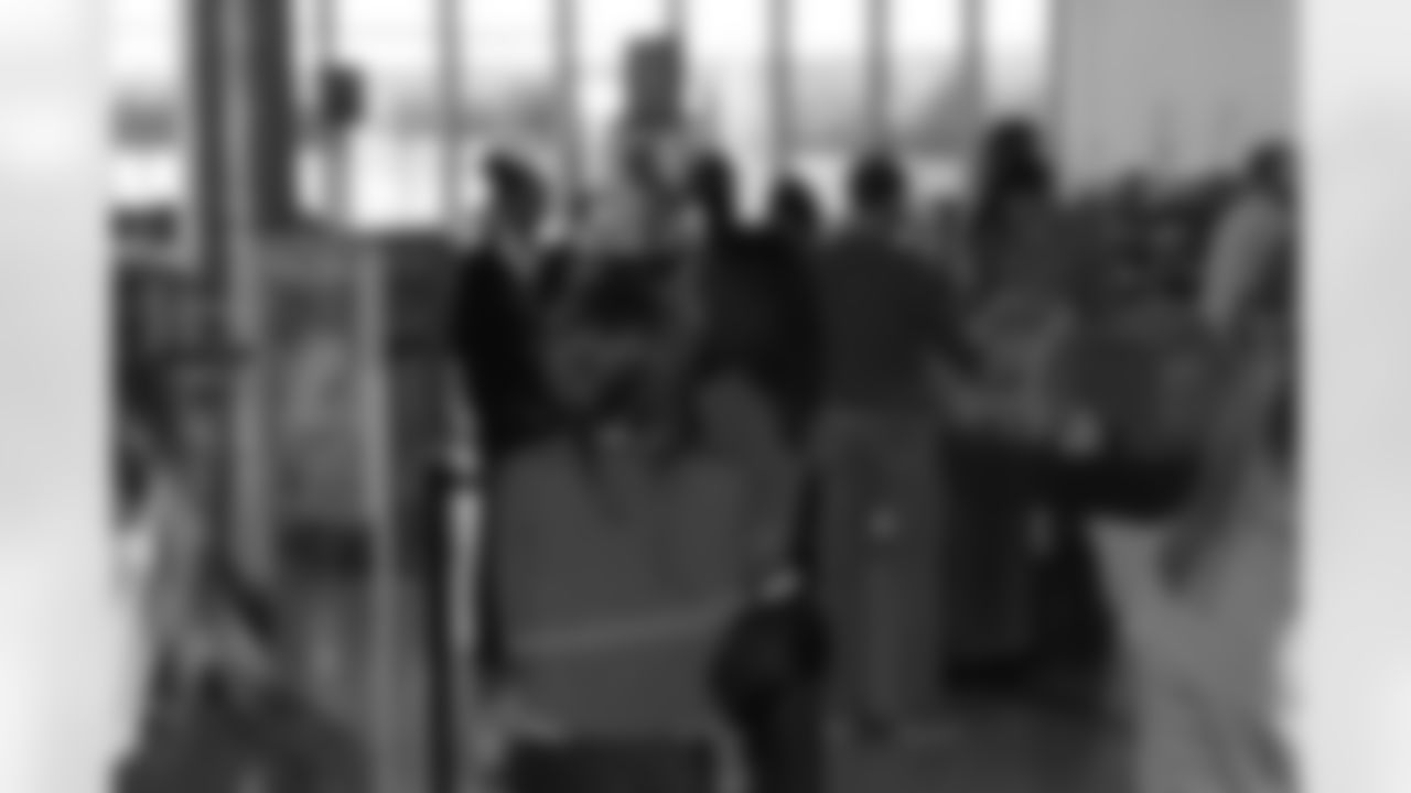Several Falcons traded places with AirTran workers to marshal planes, take tickets and greet passengers // Trading Places - AirTran // Nov. 1, 2011 // Atlanta -