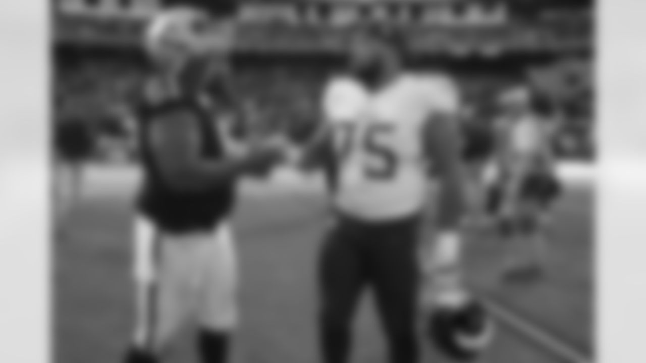 Oakland Raiders center Rodney Hudson (61) greets Tennessee Titans offensive guard Jamil Douglas (75) after an NFL football game in Oakland, Calif., Sunday, Dec. 8, 2019. (AP Photo/Ben Margot)