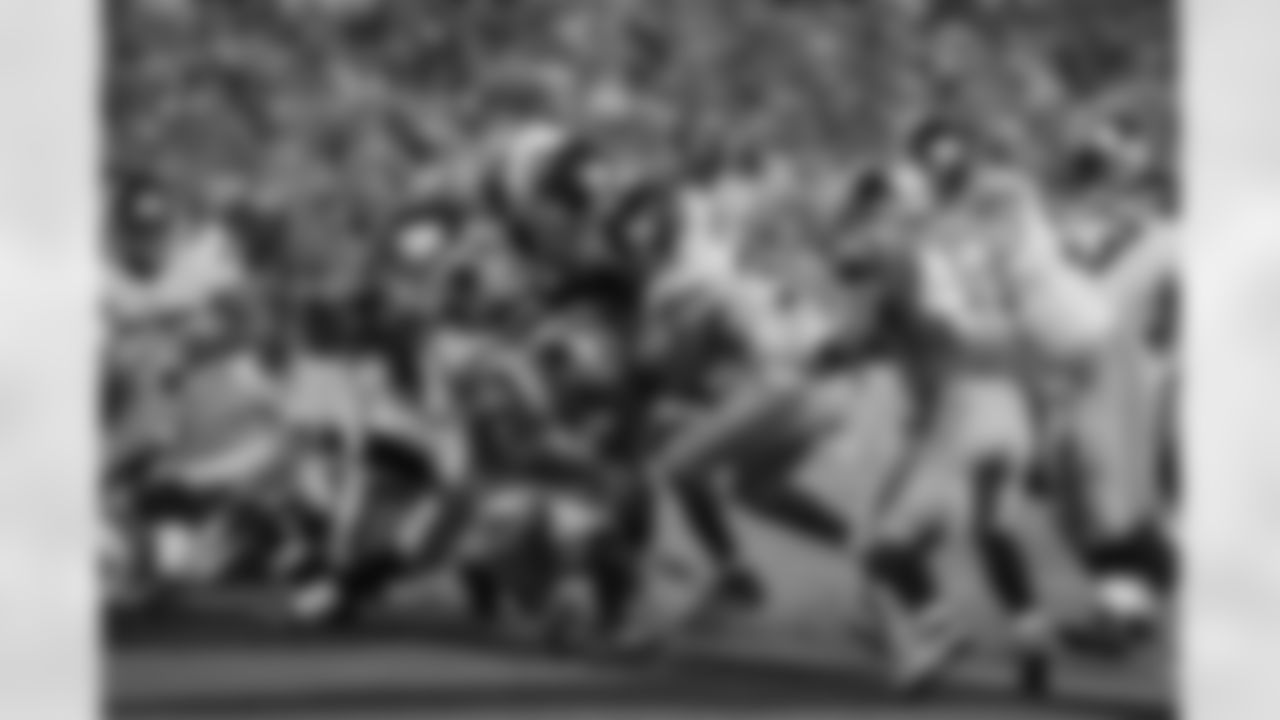 New York Giants' Andre Brown (35) gets some help from teammate, Henry Hynoski (45) as he muscles over Carolina Panthers' Chris Gamble (20) and Luke Kuechly (59) for a touchdown during the first half of an NFL football game in Charlotte, N.C., Thursday, Sept. 20, 2012. The Giants won 36-7. (AP Photo/Bob Leverone)