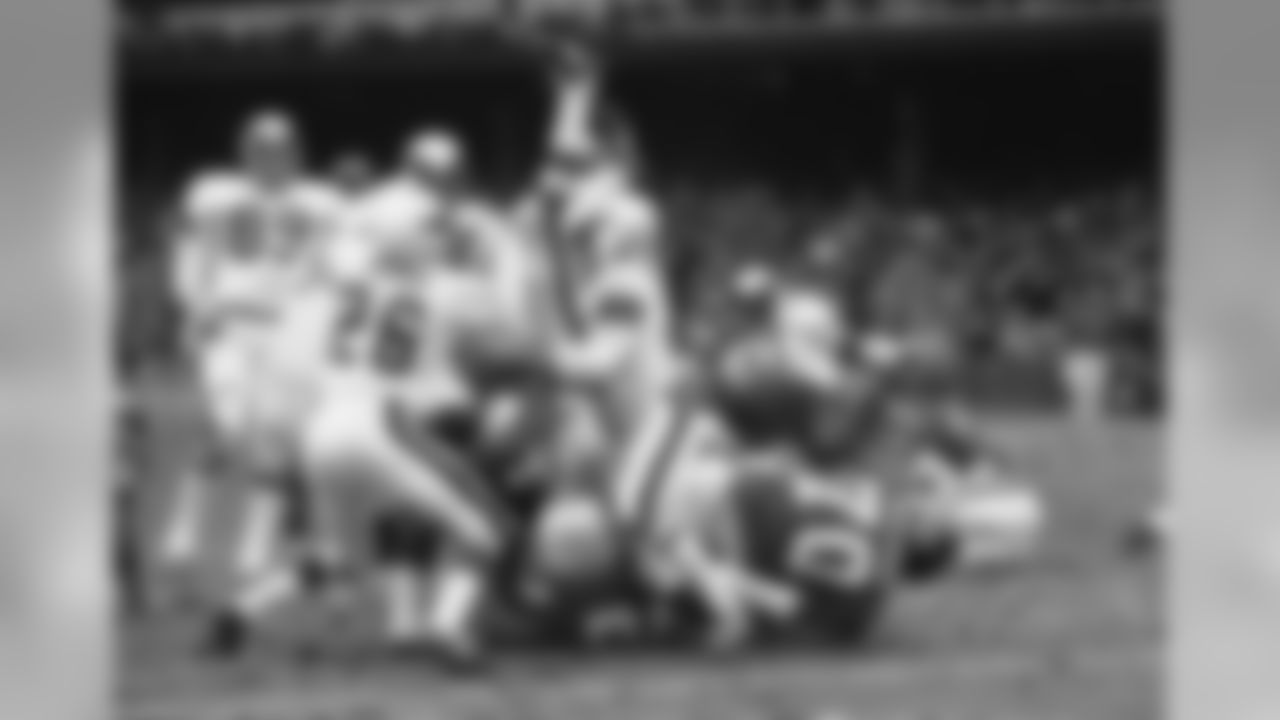 New York Giants? running back Rocky Thompson (22) is dumped head first by Philadelphia Eagles defense when he attempted to score from five yard line on first down play in first quarter at Yankee Stadium in New York on Dec. 19, 1971. Thompson scored on the following play in the same quarter. Al Nelson (26) left corner back of the Philadelphia Eagles, and teammate Bill Bradley (28) right safety are in on the action. Tucker Frederickson (24) is on the bottom of the play. Eagles won, 41-28. (AP Photo/RFS)