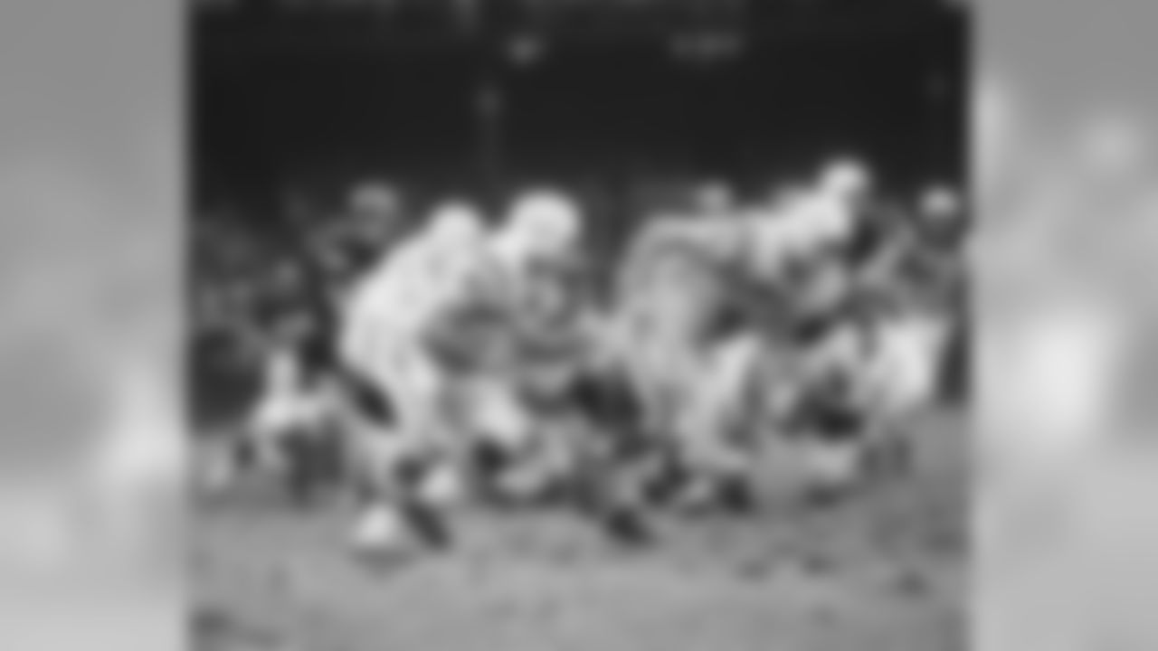 Baltimore Colts Dan Sullivan (71) lead blocks for Jerry Hill (45) during a game agains the New York Giants on November 3,1968 at Yankee Stadium in the Bronx, New York. The Baltimore Colts beat the New York Giants 26-0. John Williams played for 12 years, with 2 different teams.(David Durochik via AP)