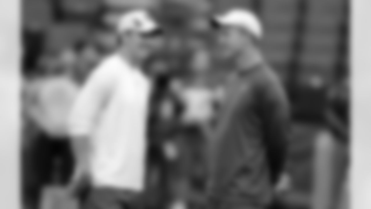 FILE - This Sept. 19, 2010 file photo shows New York Giants quarterback Eli Manning, left, talking with his brother, Indianapolis Colts quarterback Peyton Manning, before an NFL football game in Indianapolis. Eli says he didn't want to host "Saturday Night Live" after his first Super Bowl victory because it came so soon after big brother Peyton's appearance a year earlier. He sent word back to the show's executives that perhaps he'd host if he won another championship. Sure enough, the Giants quarterback said yes after his second title and will star in the comedy sketches Saturday. (AP Photo/Darron Cummings, File)