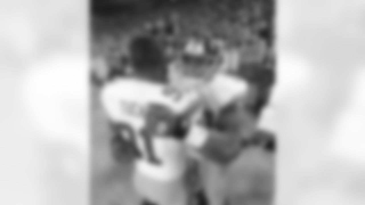 New York Giants running back Brandon Jacobs hugs defensive end Justin Tuck (91) during an NFL football game against the Green Bay Packers on Sunday January 15, 2012 at Lambeau Field in Green Bay, Wisconsin
(AP Photo/Evan Pinkus)