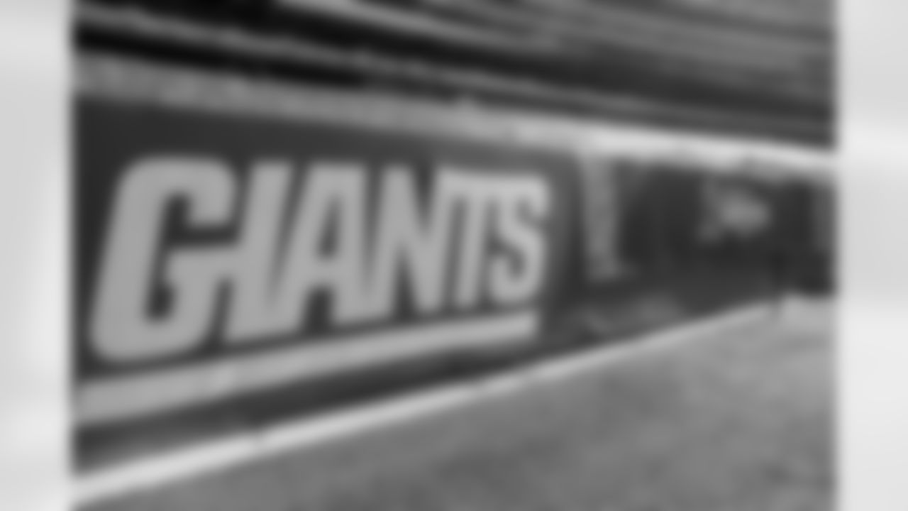 A detail view of a New York Giants banner and a Salute to Service banner on the sideline before an NFL football game between the New York Giants and the Las Vegas Raiders, Sunday, Nov. 7, 2021, in East Rutherford. N.J. (AP Photo/Steve Luciano)