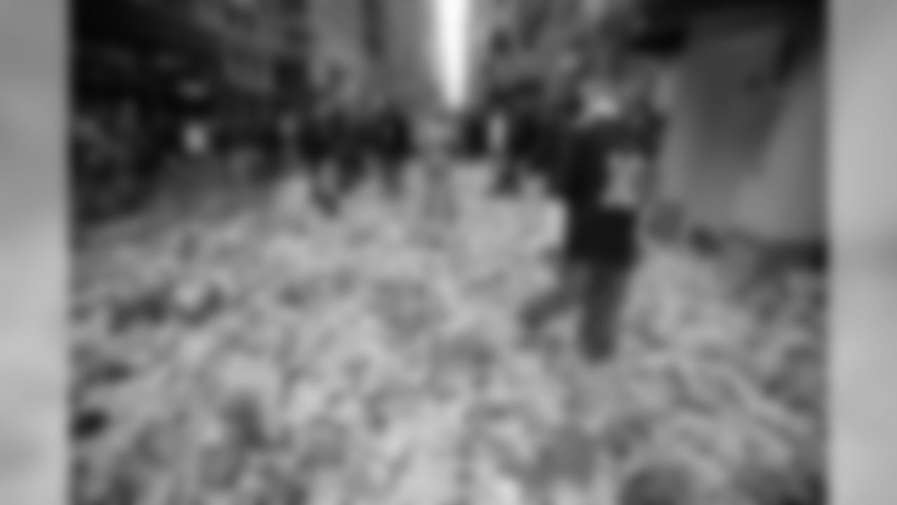 New York Giants fan Ryan Schnepf, 23, walks through the confetti strewn on Broadway after the Super Bowl parade Tuesday, Feb. 5, 2008 in New York. (AP Photo/Gary He)