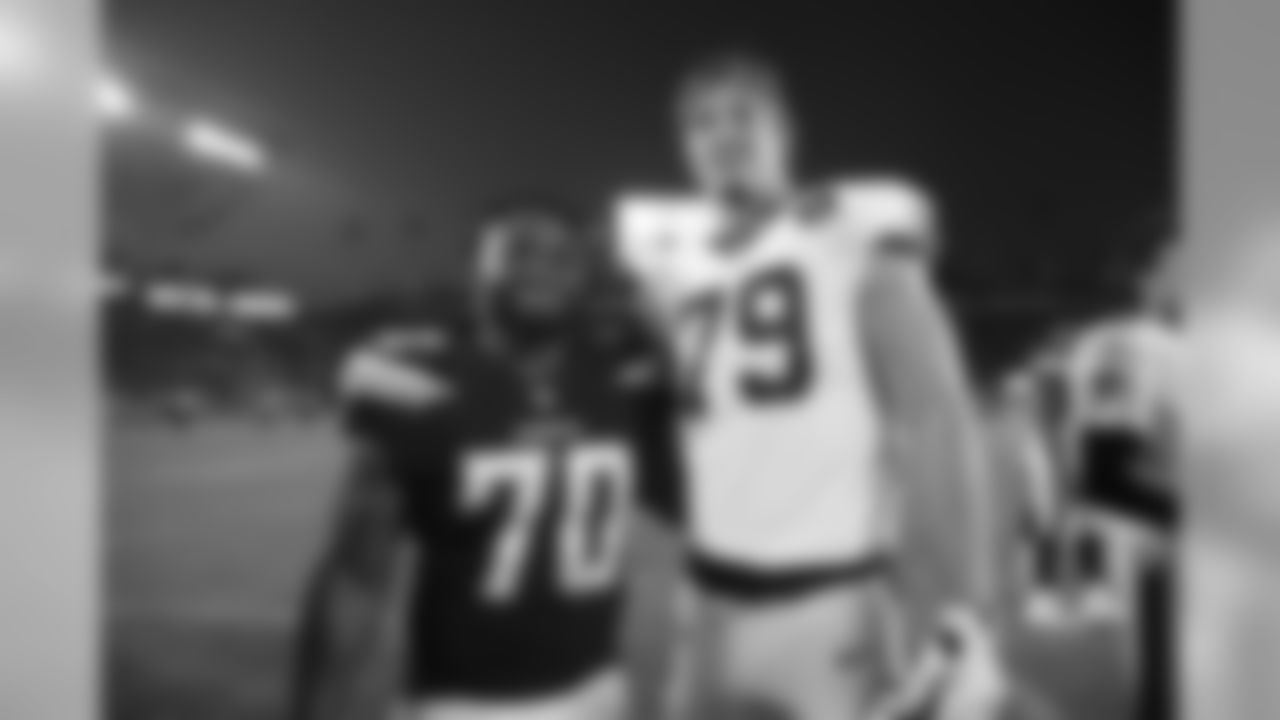 Nate Wozniak, right, and Los Angeles Chargers defensive tackle Steven Richardson pose for a picture after an NFL preseason football game Saturday, Aug. 25, 2018, in Carson, Calif. (AP Photo/Jae C. Hong)