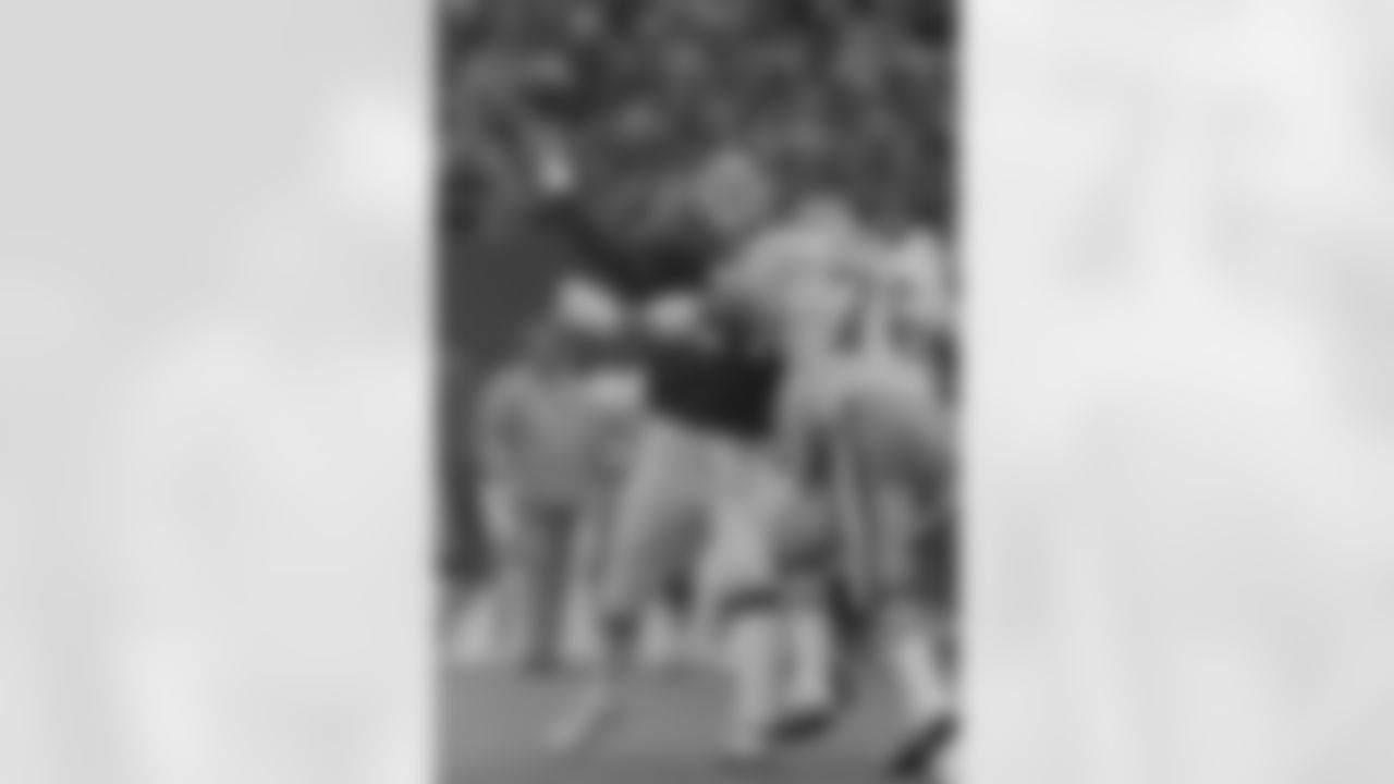 New York Giants quarterback Phil Simms is hit by San Francisco 49ers Dwaine Board as he gets off a pass during first half NFL playoff action at Giants Stadium in East Rutherford, N.J., Sunday, Jan. 4, 1987. Simms helped engineer a 49-3 victory over the 49ers. (AP Photo/Rusty Kennedy)