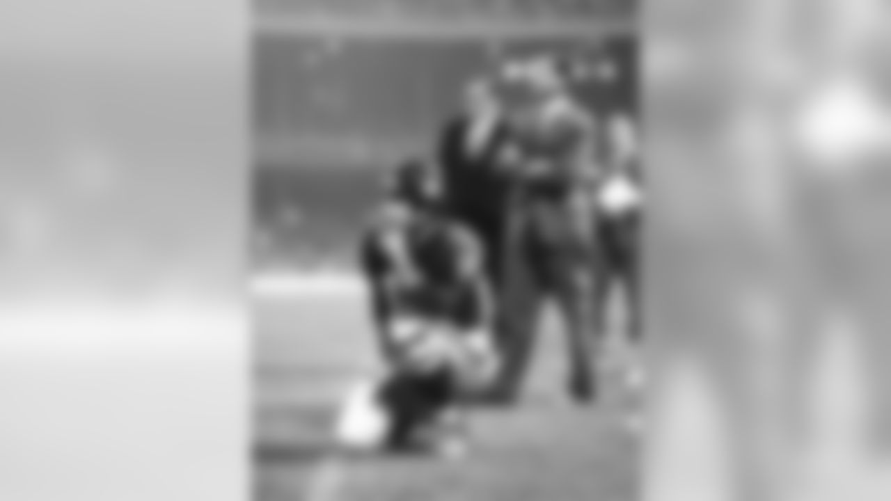 Y.A. Tittle, veteran quarterback of the New York Giants, watches play from the sidelines in first half of Giants-Washington Redskins game at New York?s Yankee Stadium on Sept. 25, 1964. The Giants? sharpshooting passer who was injured the week before in game with Steelers, got into play in the second half and led the giants to a 13-10 win. Wearing light suit in background is giants Coach Allie Sherman. (AP Photo/Marty Lederhandler)
