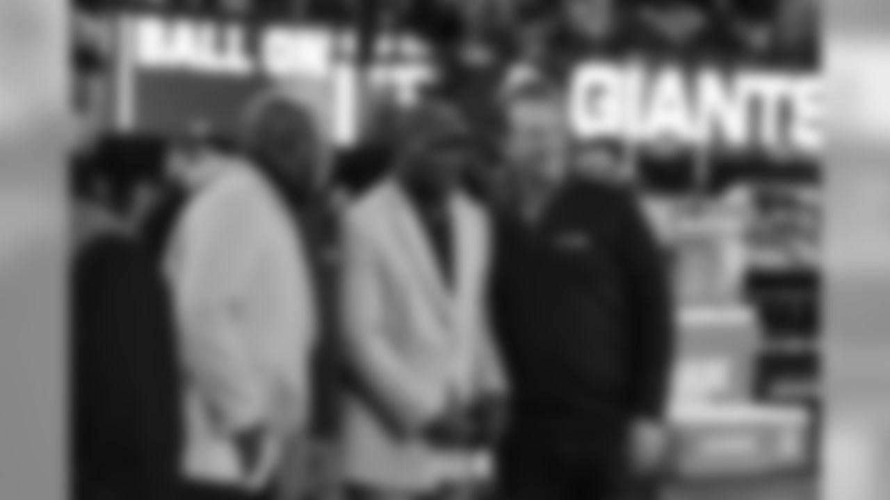 Giants Hall of Famers Lawrence Taylor (left) and Harry Carson (middle) pose with former teammate Gary Reasons during halftime of the Giants-Colts game. Reasons played linebacker with Taylor and Carson during his seven seasons with the Giants.
