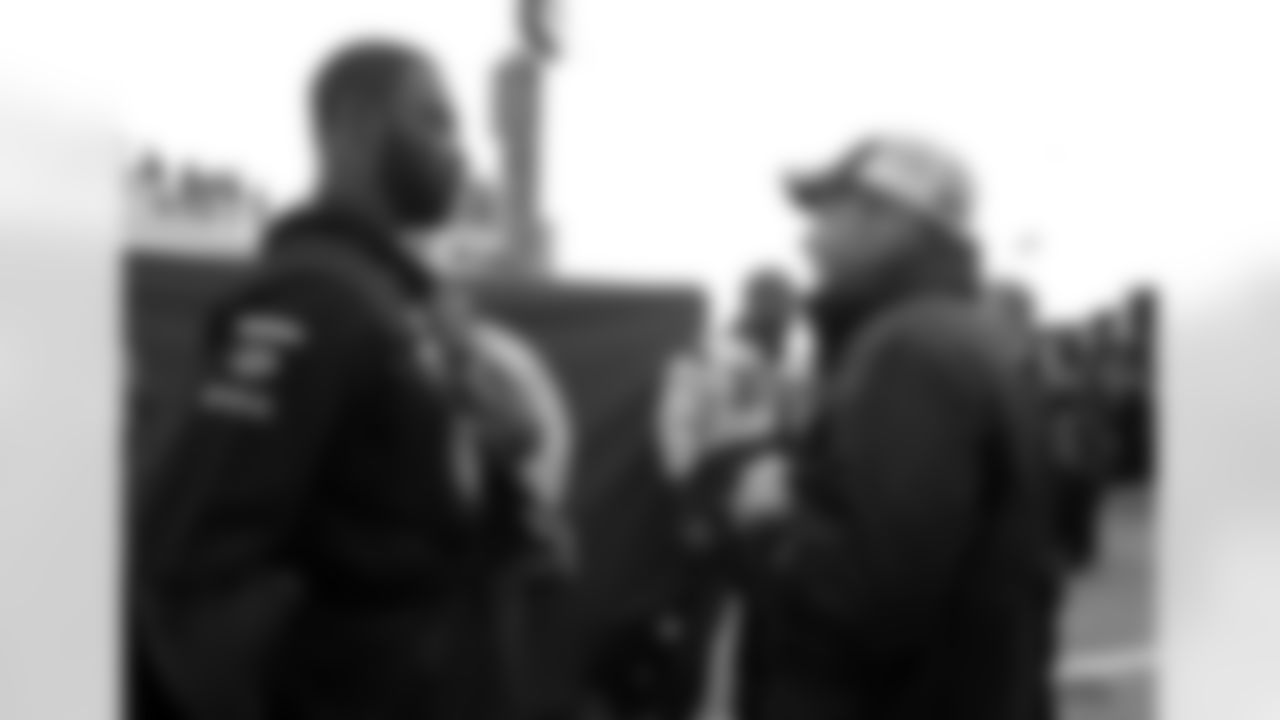 New York Giants NFL football defensive linemen Justin Tuck, left, talks with Jared Erspamer, of Omaha, Neb., while walking through the garage area with teammate Osi Umenyiora, rear center, prior to the NASCAR Daytona 500 Sprint Cup series auto race at Daytona International Speedway in Daytona Beach, Fla., Sunday, Feb. 26, 2012. (AP Photo/Phelan M. Ebenhack)