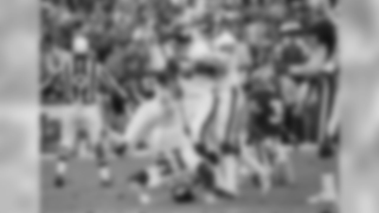 New York Giants quarterback Jeff Hostetler rolls backward into a handstand as Lawrence Taylor (56) hugs kicker Matt Bahr after game-winning field goal in final second of NFC championship game in San Francisco, Jan. 20, 1991. Hostetler held the ball then rolled into the handstand. Giants go to Super Bowl with 15-13 victory. (AP Photo/Paul Sakuma)