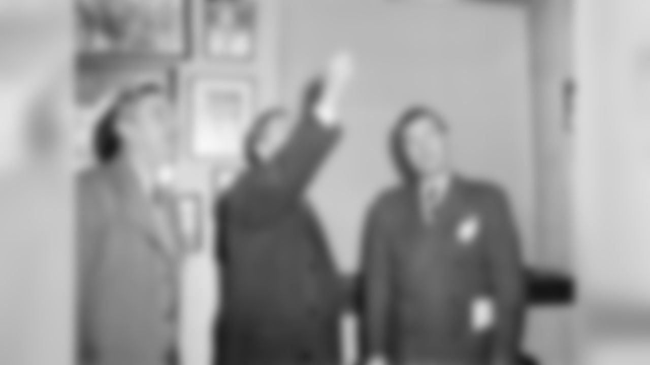Pro football league commissioner Elmer Layden, center, flips a coin in Washington, D.C., Dec. 12, 1943, to decide the site of the play off game between the Washington Redskins and the New York Giants, as Redskins' owner George Marshall, left, and Giants' president John Mara, right, watch for coin to come down. New York got the nod as Mara called it right. (AP Photo/Herbert K. White)