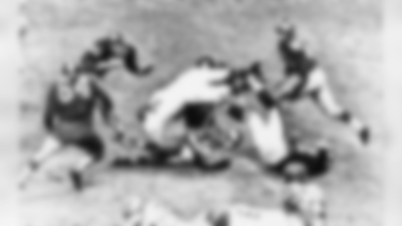 Philadelphia Eagle's back Howard (Hopalong) Cassady, in white uniform, is upended by New York giants defenders on the play in which he suffered a fractured right leg at New York's Yankee Stadium, Nov. 18, 1962. Cassady, former all-America at Ohio State, was brought down returning a giant kick off in fourth period. Identifiable giants are Ken Byers, 60, Mickey Walker, 64, and Paul Dudley, 23. Giants won the game, 19-14. (AP Photo)