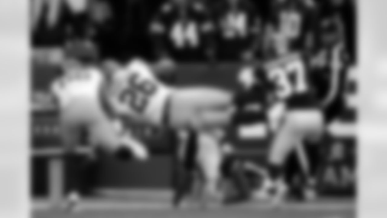 New York Giants running back Saquon Barkley (26) dives over Washington Redskins cornerback Aaron Colvin for a touchdown ona long run during the first half of an NFL football game, Sunday, Dec. 22, 2019, in Landover, Md. (AP Photo/Alex Brandon)