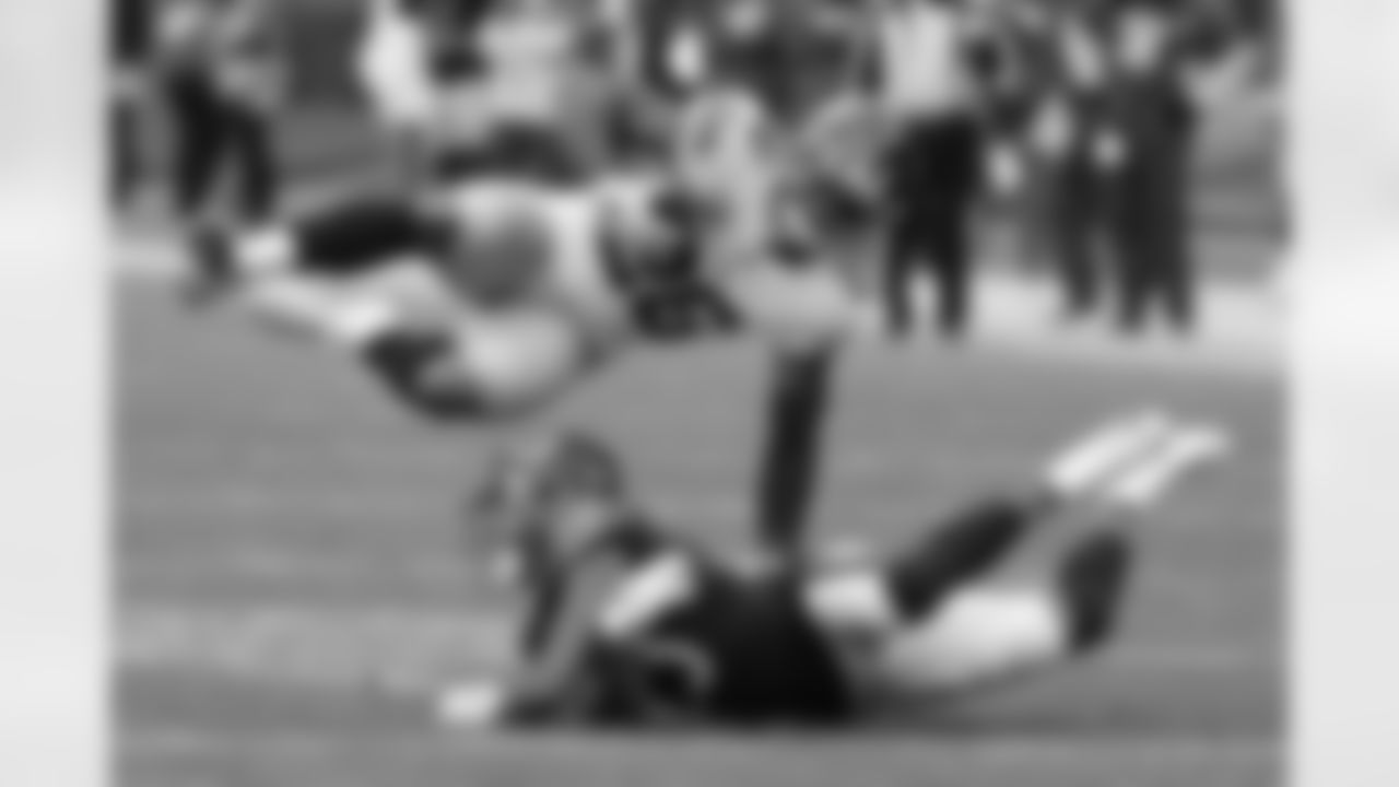 New York Giants running back Saquon Barkley (26) flips over Chicago Bears cornerback Kyle Fuller (23) during the second half of an NFL football game in Chicago, Sunday, Nov. 24, 2019. (AP Photo/Charles Rex Arbogast)