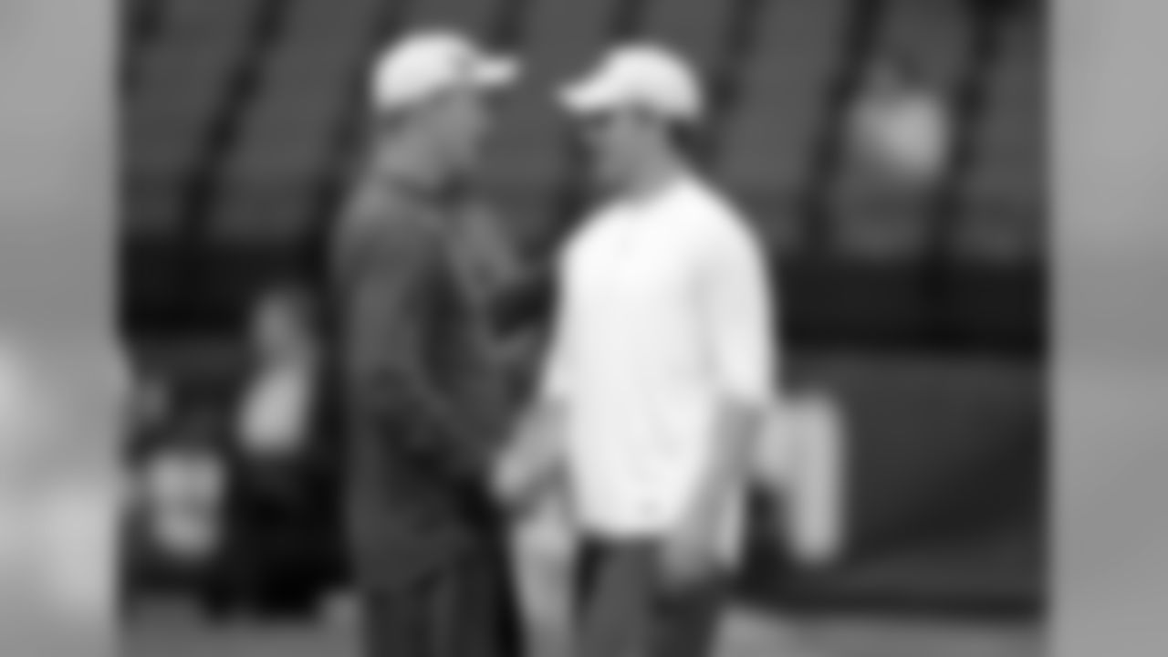 Indianapolis Colts quarterback Peyton Manning, left, and his brother New York Giants quarterback Eli Manning talk before the start of an NFL football game in Indianapolis, Sunday, Sept. 19, 2010. (AP Photo/Michael Conroy)