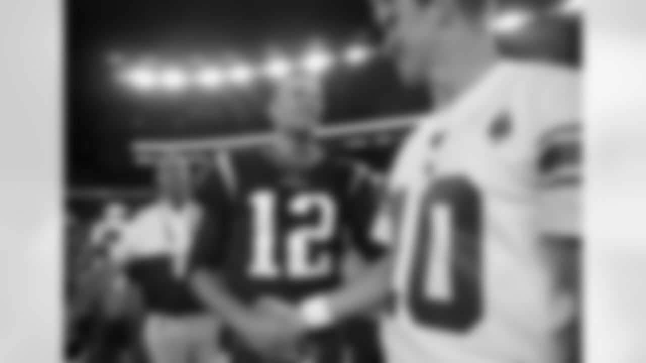 New England Patriots quarterback Tom Brady (12) and New York Giants quarterback Eli Manning speak at midfield after an NFL preseason football game, Thursday, Aug. 29, 2019, in Foxborough, Mass. (AP Photo/Elise Amendola)