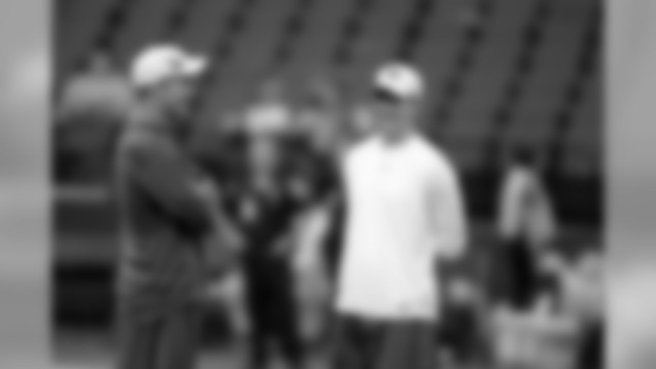Indianapolis Colts quarterback Peyton Manning, left, and his brother New York Giants quarterback Eli Manning talk before the start of an NFL football game in Indianapolis, Sunday, Sept. 19, 2010. (AP Photo/Michael Conroy)