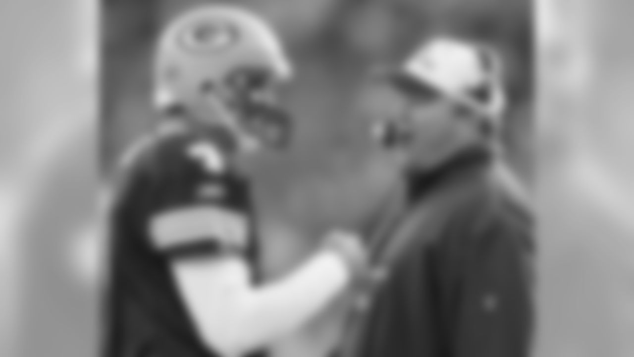 Green Bay Packers coach Mike McCarthy congratulates quarterback Brett Favre (4) after a touchdown pass during the first half of an NFL football game against the Carolina Panthers Sunday, Sept. 18, 2007, in Green Bay, Wis. (AP Photo/Morry Gash)