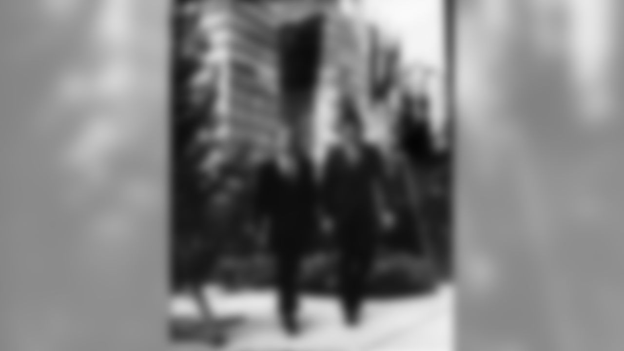 New York Giants quarterback Fran Tarkenton, left, and Philadelphia Eagles quarterback Norm Snead walk through what seems to be a forest in front of a buiding on New York's Park Avenue, Nov. 27, 1967. The two men walked past the trees, part of Christmas preparations, en route to a luncheon at the Pro Quarterback Club. The Giants beat the Eagles yesterday, 44-7. (AP Photo/Harry Harris)